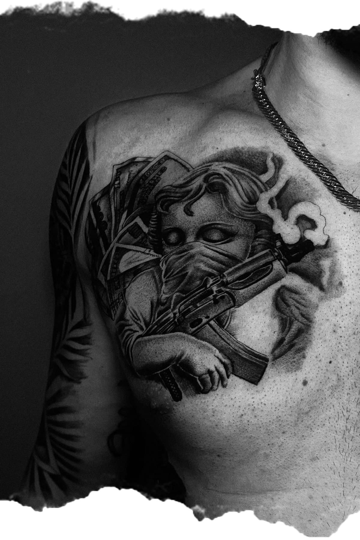 Black and grey realistic tattoo on chest